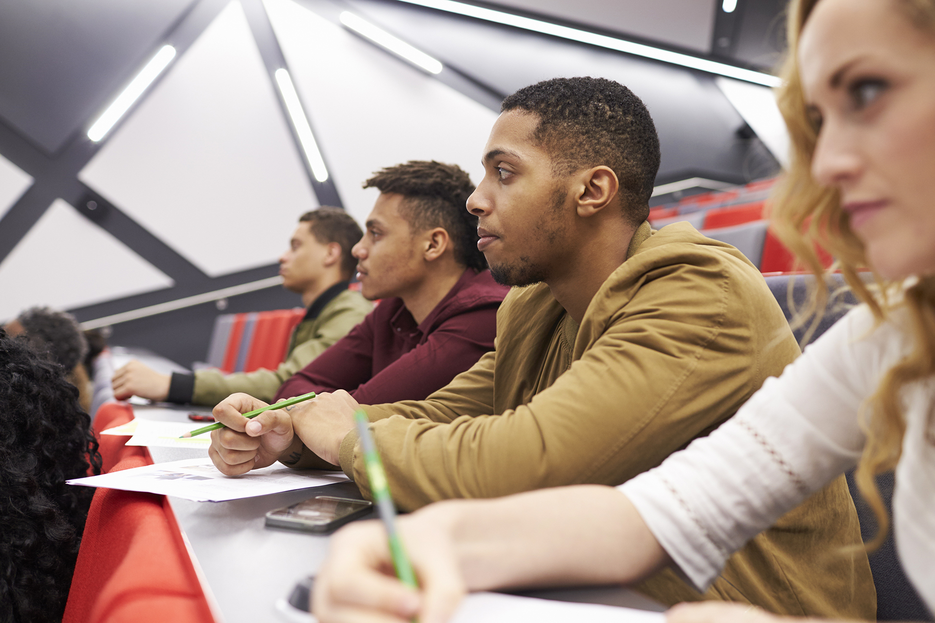 students listening to lecture at university lecture theatre